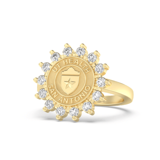 Gold class ring with 'UT Health San Antonio' seal and white stones on a white background