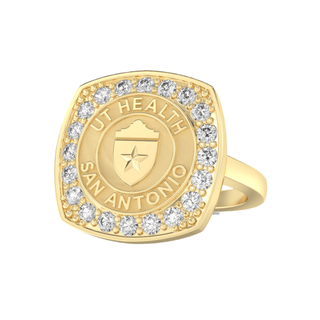 Gold class ring with 'UT Health San Antonio' engraving on a yellow gold seal on a white background