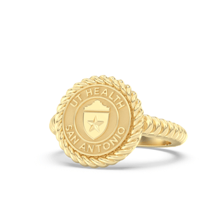 Gold class ring with U.T. Health San Antonio shield seal on a white background