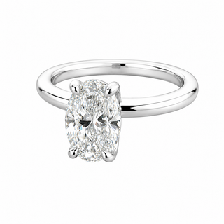 An oval brilliant cur diamond solitaire engagement ring in a polished white gold solitare band, shown on a plain white background.