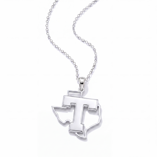 A silver pendant necklace featuring a stylized letter 'T' integrated with the outline of Texas, suspended from a delicate silver ball chain against a clean white background.