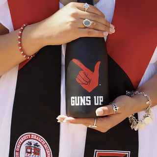 Texas Tech Class Ring Purchased At San Jose Jewelers | Customer showing off her Texas Tech Graduation Ring while holding a champaign bottle at graduation