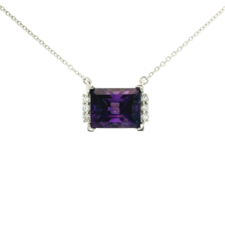 Necklace with a amethyst gemstone pendant on a white background