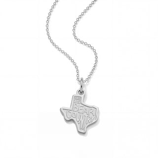 A silver necklace featuring a pendant shaped like the state of Texas, with the engraved text 'THIS IS BEAR COUNTRY' inside the state outline, shown on a clean white background.