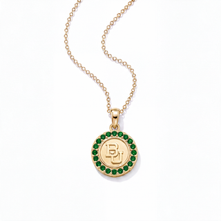 A gold pendant necklace featuring a circular medallion with a green gemstone border and an engraved 'BJ' monogram in the center, displayed on a clean white background.