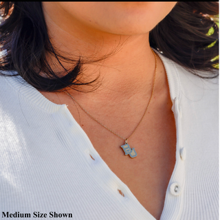 Necklace with medium Baylor University  BU pendant worn by a person in a white shirt.