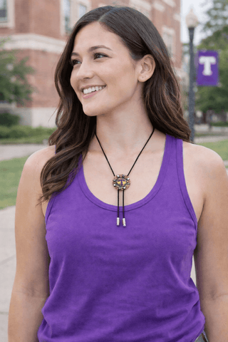 tarleton state university round yellow gold bolo tie with gold texas and purple tarleton t with purple stones on cowgirl