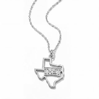 A silver necklace featuring a pendant shaped like the state of Texas, with the word 'TEXAS' cut out in the center, suspended from a delicate silver chain against a plain white background.