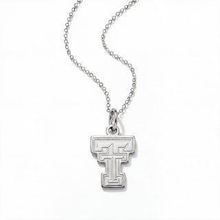 A silver pendant necklace featuring a stylized block letter 'T' with an integrated 'T' inside, suspended from a delicate silver ball chain against a plain white background.