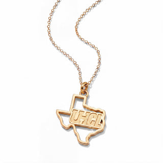 A yellow gold necklace featuring a pendant shaped like the state of Texas, with the letters 'UHCL' inlaid across the center, suspended from a delicate cable chain on a white background.