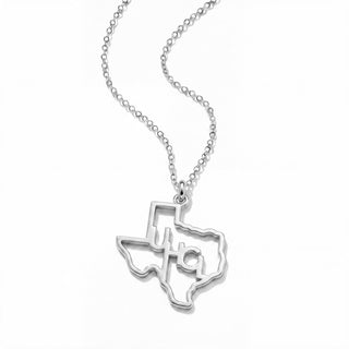 A silver necklace featuring a pendant shaped like the state of Texas, with a cutout cross design in the center, shown on a clean white background.
