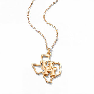 A gold necklace featuring a pendant shaped like the state of Texas with the letters 'UH' cut out in the center, suspended from a delicate gold chain on a white background.