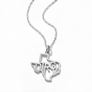 A silver necklace featuring a pendant shaped like the state of Texas, with the letters 'UTRG' cut out in the center, displayed on a clean white background.